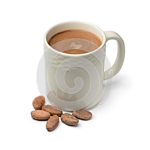 Mug with hot chocolate milk and cocoa beans