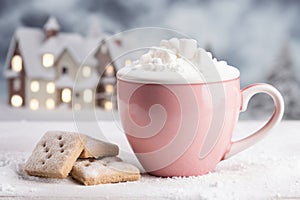 Mug of hot drink with marshmallows and gingerbread cookies on a wooden table .