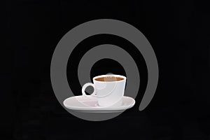 Mug of hot Turkish coffee on a saucer on a black background