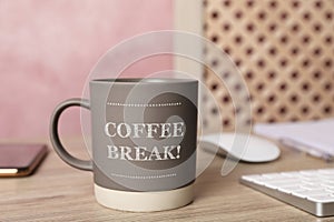 Mug with inscription Coffee Break on wooden table