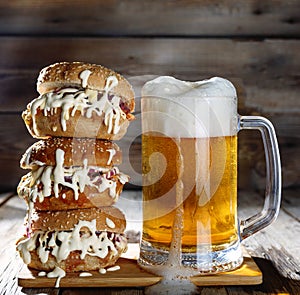 A mug of light beer and a huge burger