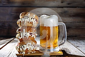 A mug of light beer and a huge burger