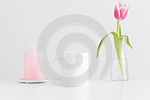 Mug mockup with pink tulips in a vase and candle on a white table