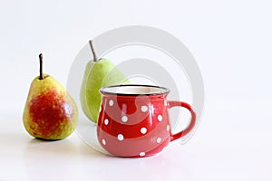 A mug of pears juice. Juicy, tasty pears on the white background. Pear autumn harvest. Free space for text. Autumn