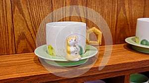Mug with a saucer and a figurine of a kitten in Wuhan