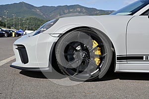 Mugello Circuit, Italy - 23 September 2021: detail of an alloy wheel rim with yellow brake caliper of a Porsche 911 in the paddock