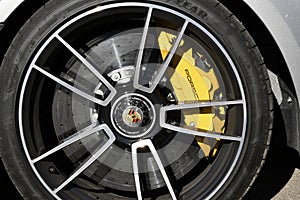 Mugello Circuit, Italy - 23 September 2021: detail of an alloy wheel rim with yellow brake caliper of a Porsche 911 in the paddock