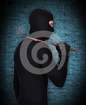 Mugger in mask with nail puller