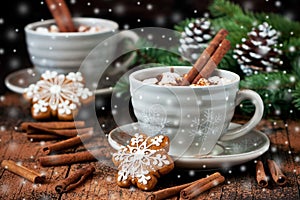 Mugs with hot chocolate and gingerbread cookies on wooden table