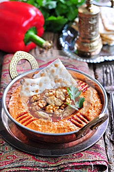 Muhammara dip of sweet peppers with walnuts, cumin, garlic and olive oil.