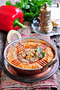Muhammara dip of sweet peppers with walnuts, cumin, garlic and olive oil.