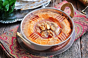 Muhammara dip of sweet peppers with walnuts, cumin, garlic and olive oil.