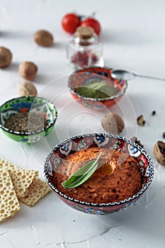 Muhammara dip of sweet peppers with walnuts, cumin, garlic and olive oil.