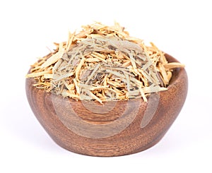 Muira Puama herbal tea in wooden bowl, isolated on white background. Natural potency wood, medicinal plant, dry tea