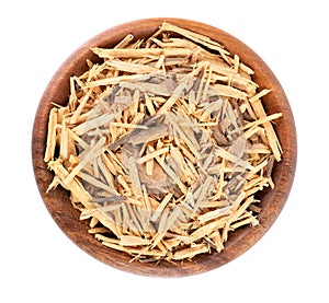 Muira Puama herbal tea in wooden bowl, isolated on white background. Natural potency wood, medicinal plant, dry tea