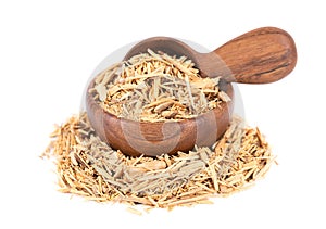 Muira Puama herbal tea in wooden bowl and spoon, isolated on white background. Natural potency wood, medicinal plant
