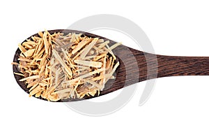 Muira Puama herbal tea in wooden spoon, isolated on white background. Natural potency wood, medicinal plant, dry tea