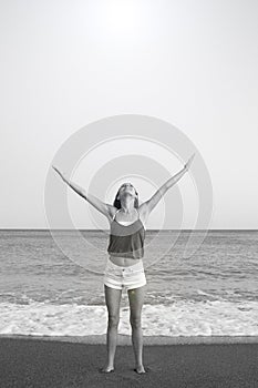 Young woman on the beach in very positive and happy attitude photo