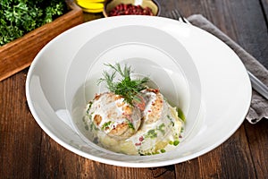 Muksun cutlets served in a white plate