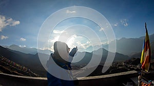 Muktinath - A man ponting on a setting sun