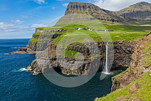 Mulafossur waterfall in Gasadalur village in Faroe Islands, North Atlantic Ocean. Nordic Natural Landscape