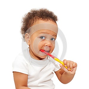 Mulatto black baby brushing teeth.