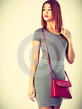 Mulatto girl gray wear with red handbag