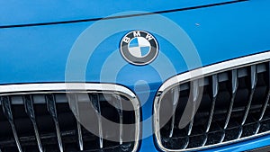 Closeup of BMW Logo on blue car front