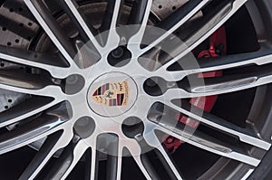 Red break on wheel of Porsche sport car