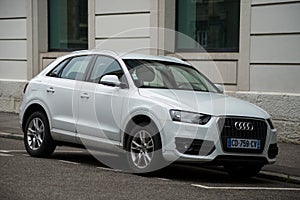 Front view of white Audi Q3 the famous german suv car parked in the street