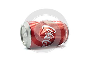 crushed can of Coca-cola on white background