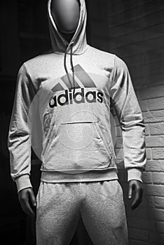 Grey sweatsuit. by Adidas on mannequin in fashion store showroom