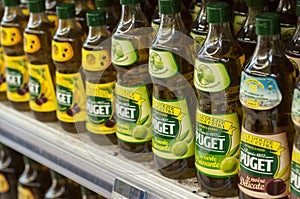 Closeup of olive oil bottles alignment from Puget Brand at Cora Supermarket