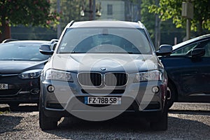 Front view of grey BMW SUV car parked in the street