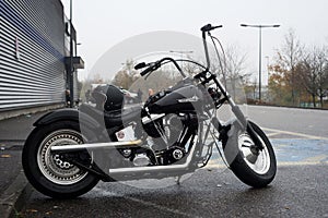 Profie view of black Harley Davidson motorbike parked in the street