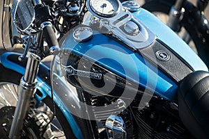 Closeup of blue and black  tank on Harley Davidson motorbike parked in the street