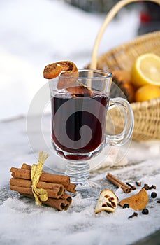 Mulled red wine in a glass mug outdoor in winter