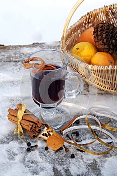 Mulled red wine on a snowy table outdoor in winter