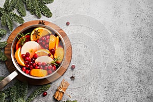 Mulled wine in with cardamom and star anise on black table with fir tree branches