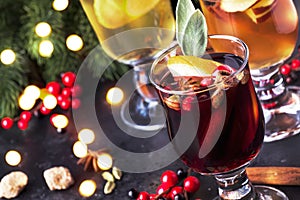 Mulled wine and mulled cider. Hot winter drinks and cocktails for christmas or new year`s eve in glass mugs with spices and citru