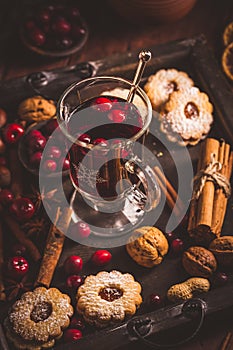 Mulled wine with cranberry and spices, Christmas cookies and candles