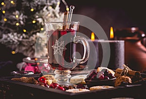 Mulled wine with cranberry and spices, Christmas cookies and candles