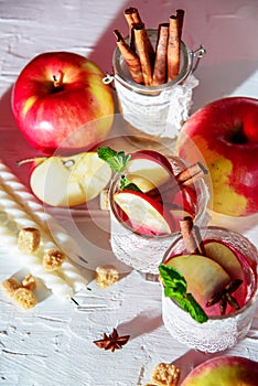 mulled wine in fishnet glasses on a light background, Apple, cinnamon, wine