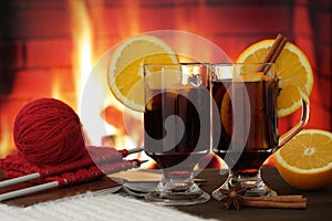 Mulled wine glasses in front of fireplace
