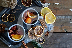 Mulled wine in gray metall mugs with orange and spices Rustic style
