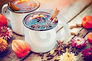 Mulled wine in mugs, spice and dry flowers.