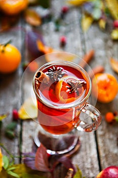 Mulled wine in mugs, spice and dry flowers and leaves. Autumn st