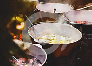 Mulled wine with oranges in large vats on Christmas market. New year and Christmas celebration concept, traditional drink