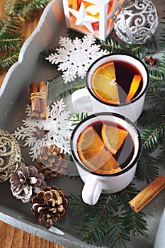 Mulled wine with spices and citrus fruit and burning lantern