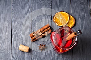 Mulled wine and spices on gray wooden background. Selective focus. Top view with copyspace.